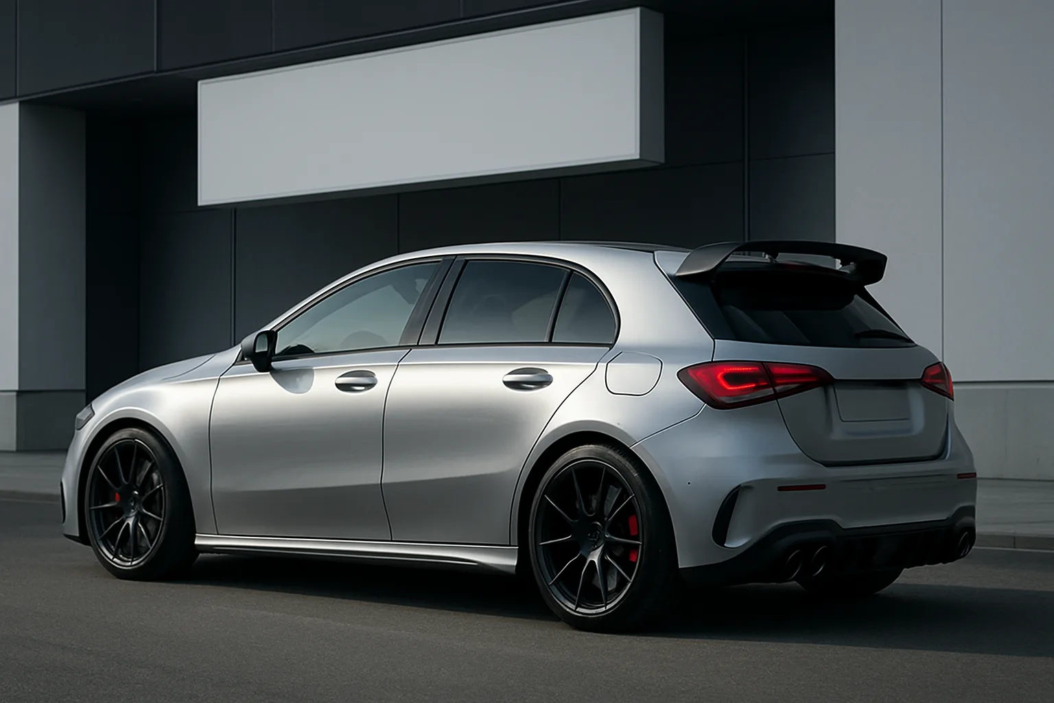 Sleek silver hatchback with black wheels and rear spoiler parked by a modern building in soft daylight