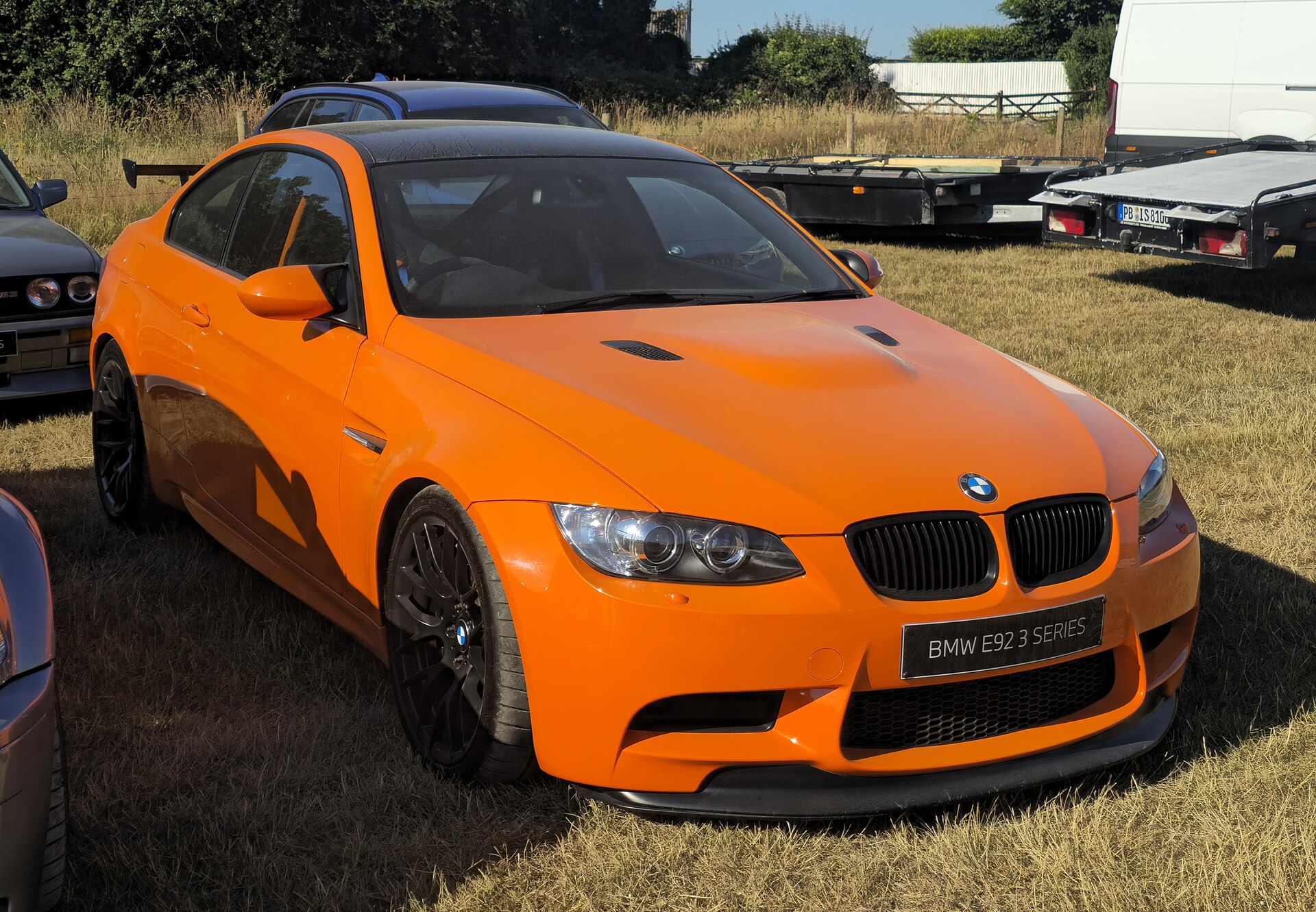BMW M3 GTS (E92) in bright orange, track-focused sports car.