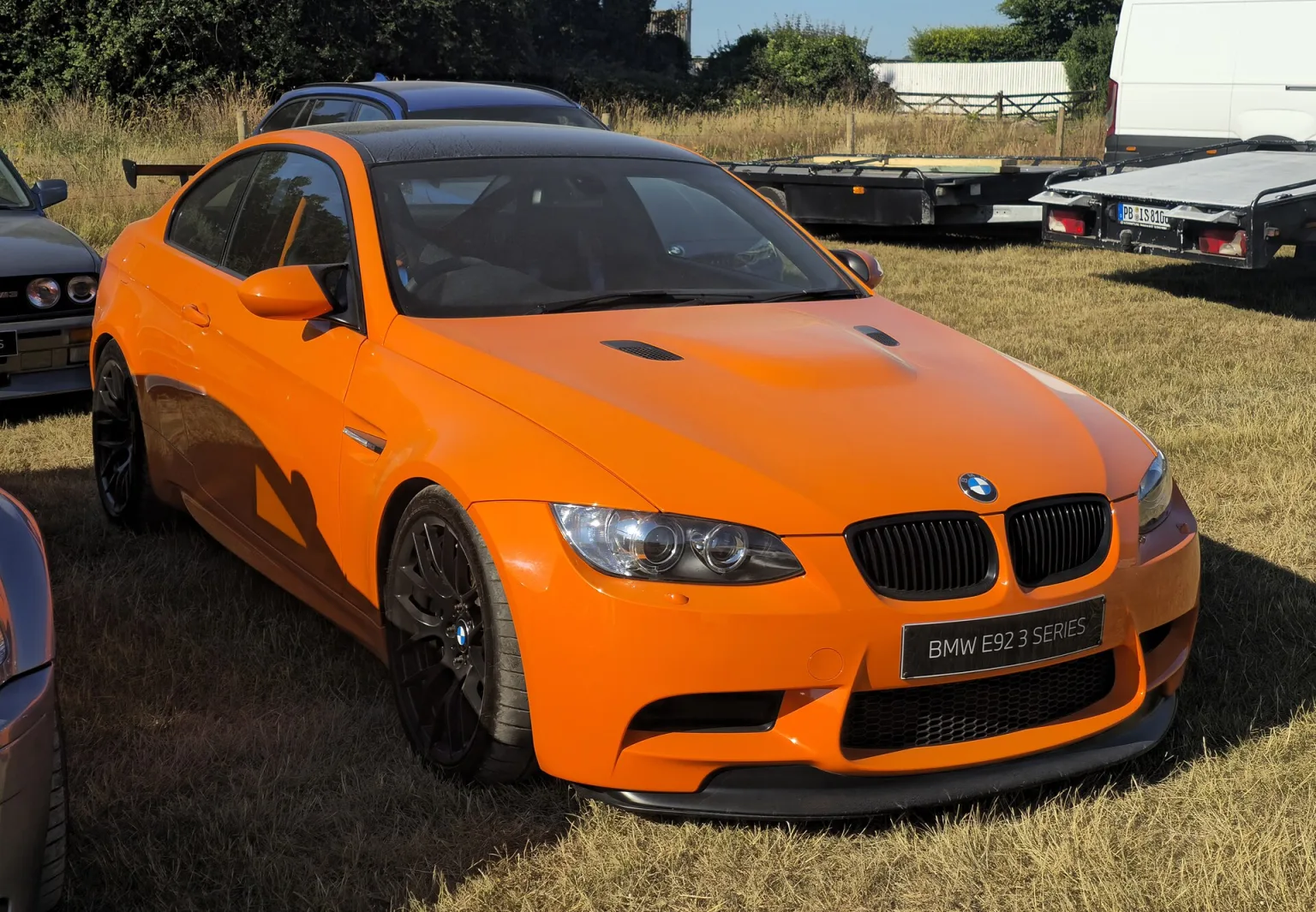 BMW M3 GTS (E92) in bright orange, track-focused sports car.