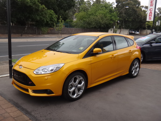 2012 Ford Focus ST in orange, front three-quarter view