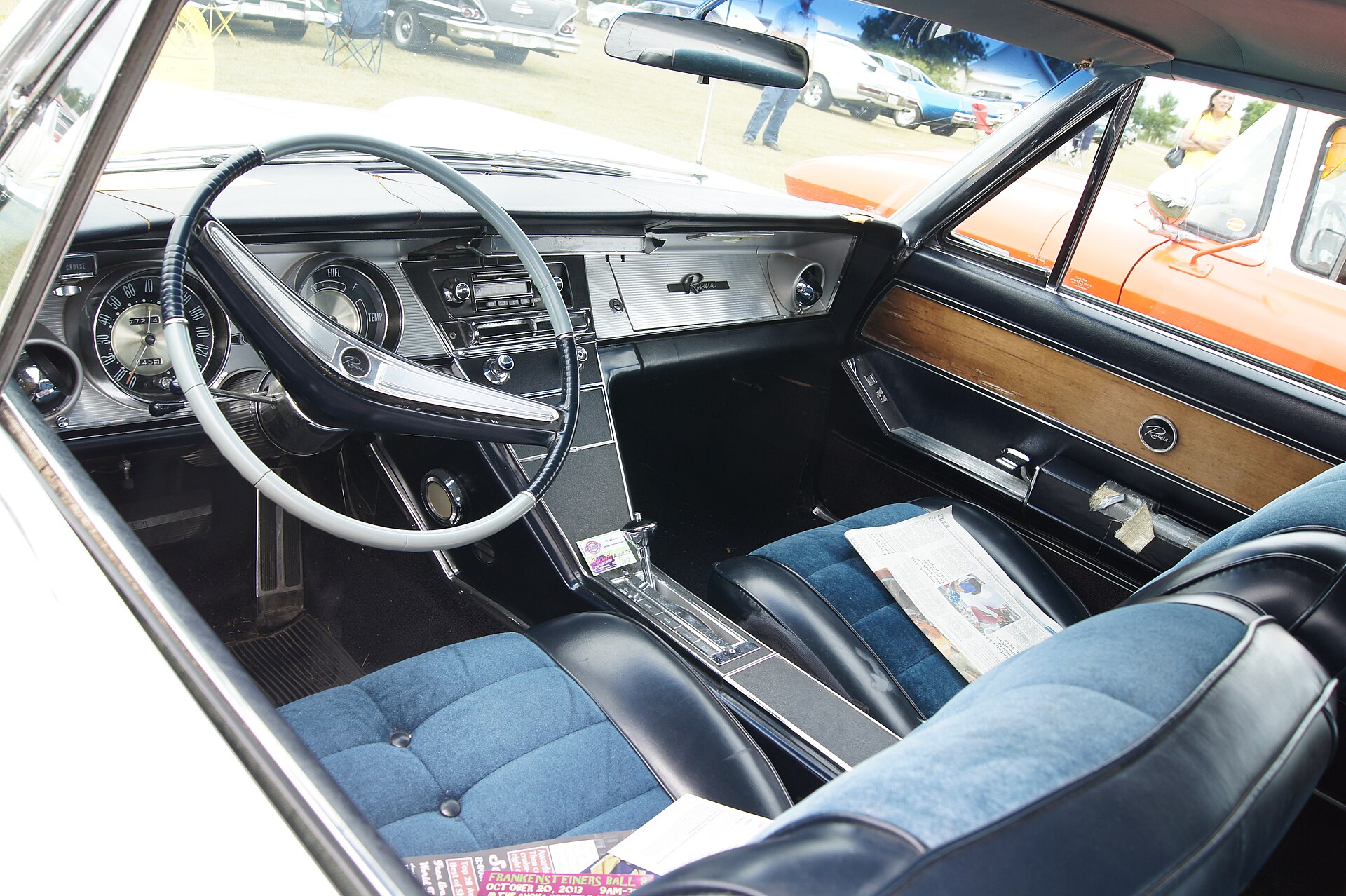 1964 Buick Riviera at a car show, front and side view