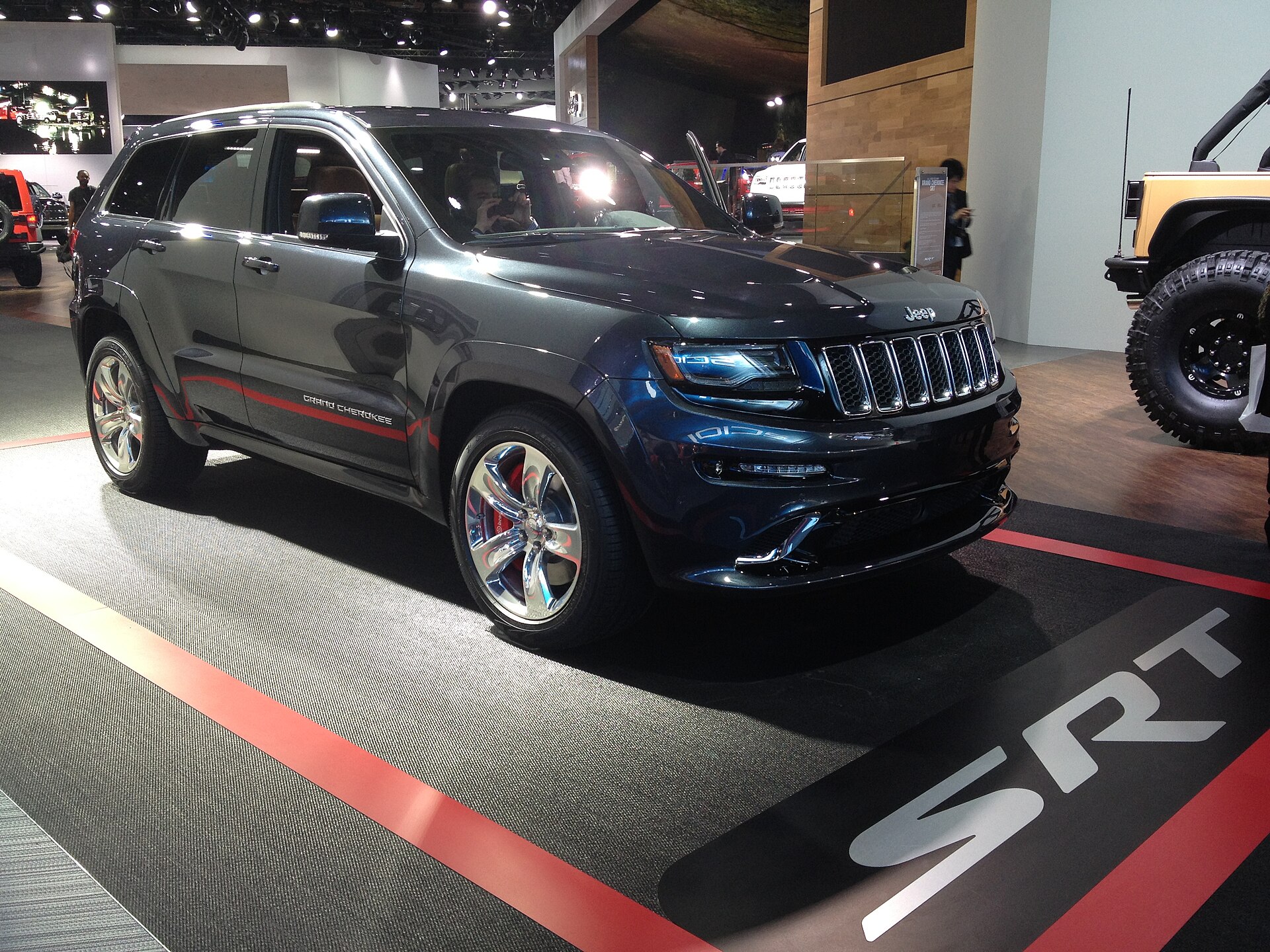 2014 Jeep Grand Cherokee SRT in silver, front three-quarter view