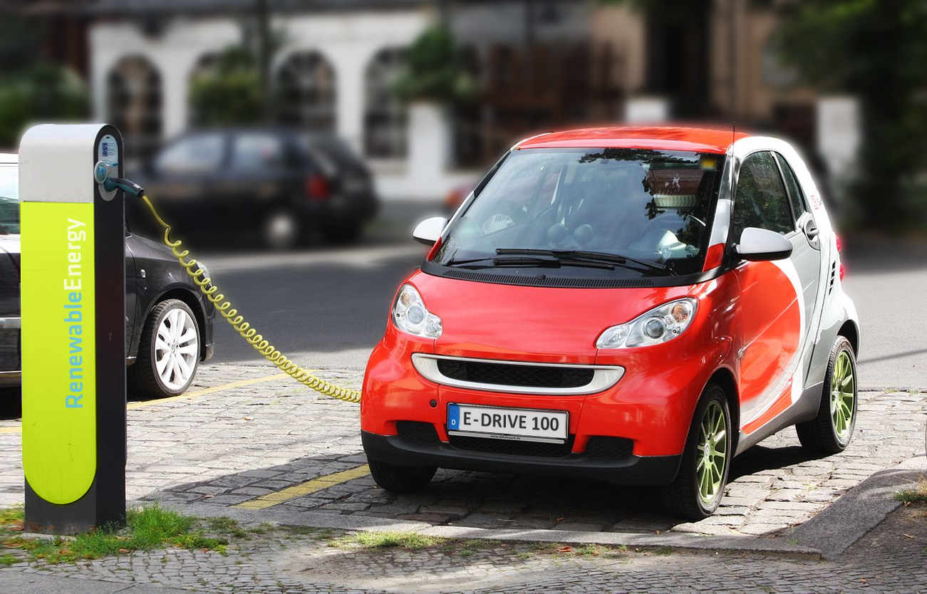 An electric car recharging at a public charging station.