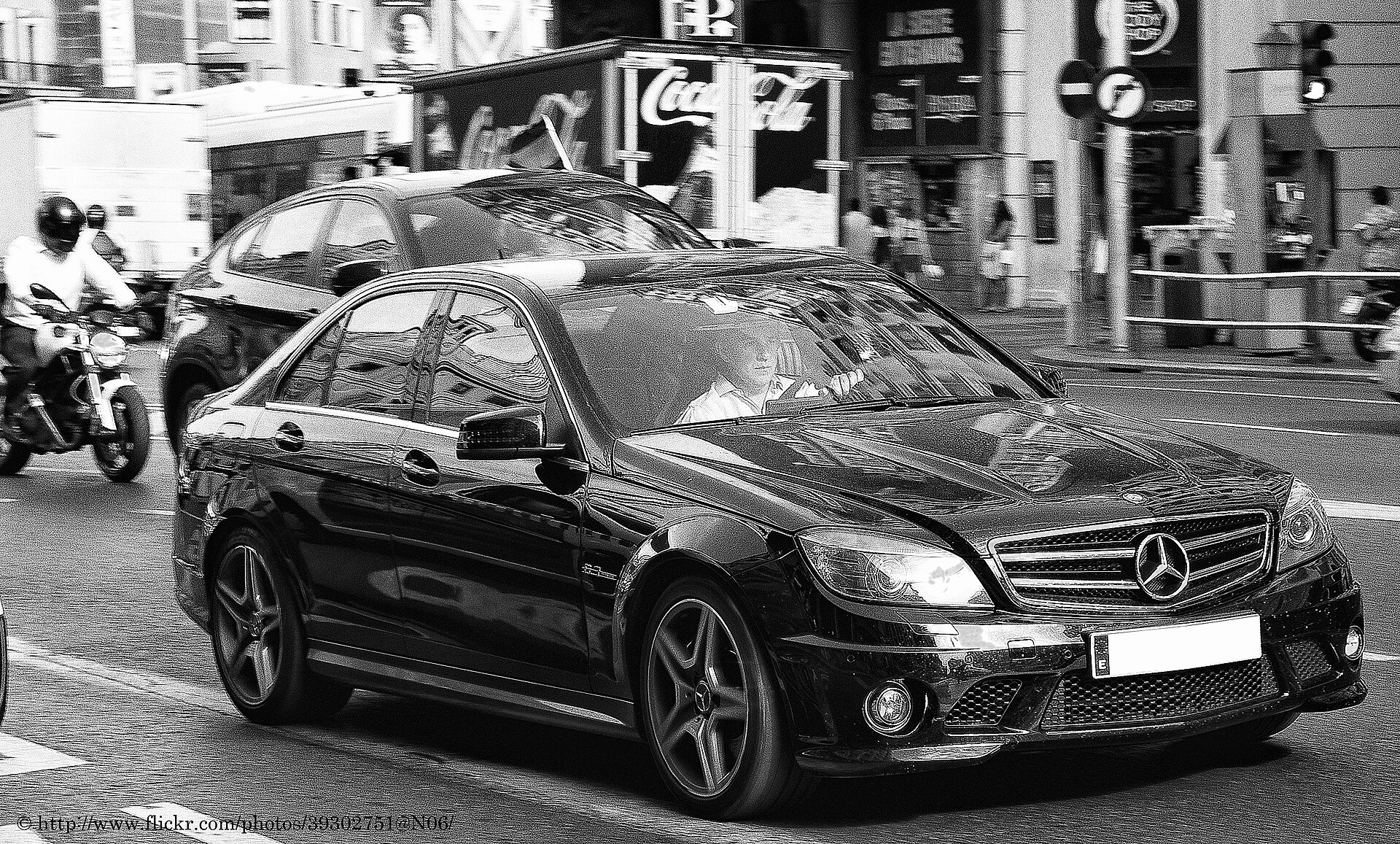 2010 Mercedes-Benz C63 AMG (W204) in silver, front three-quarter view.
