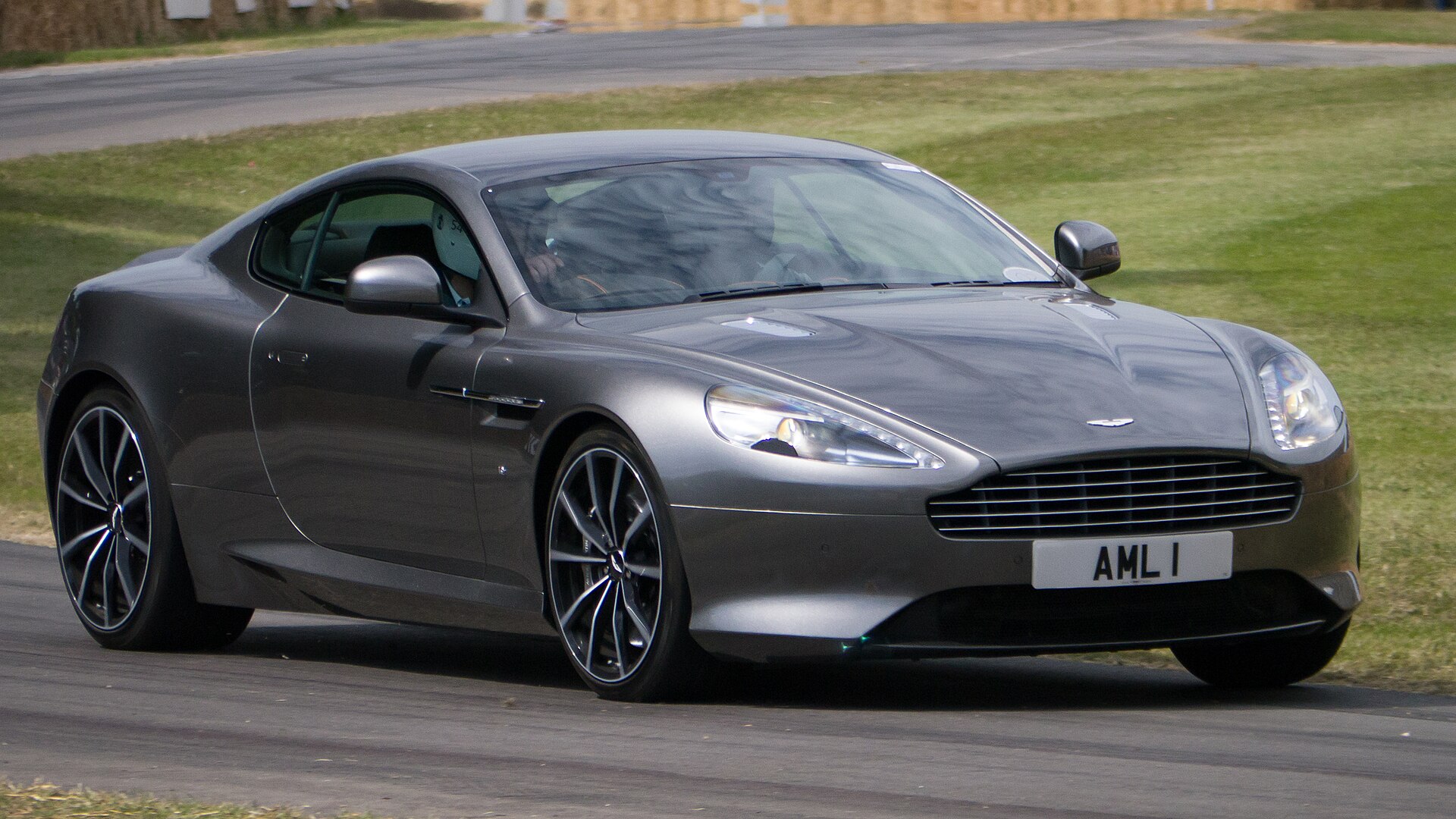 2015 Aston Martin DB9 GT at a car show, front three-quarter view.