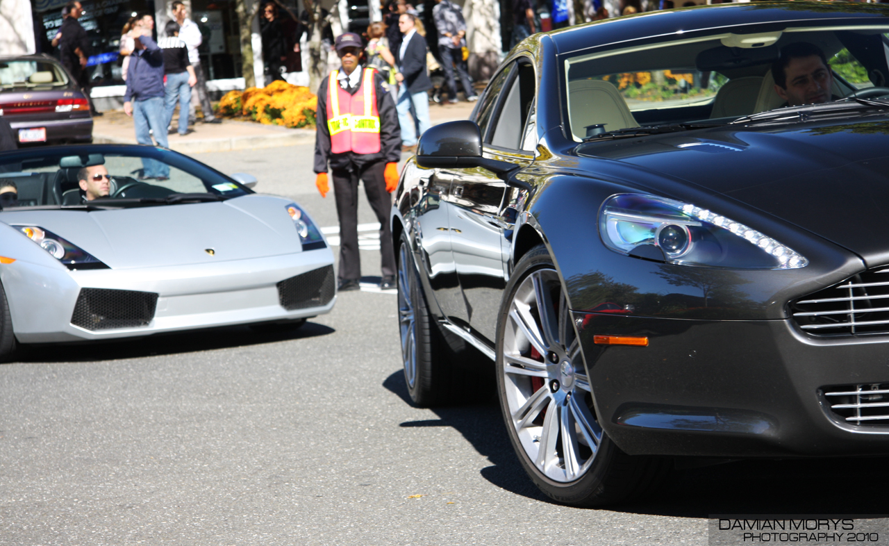 Aston Martin Rapide (first generation) next to a Lamborghini Gallardo Spyder.