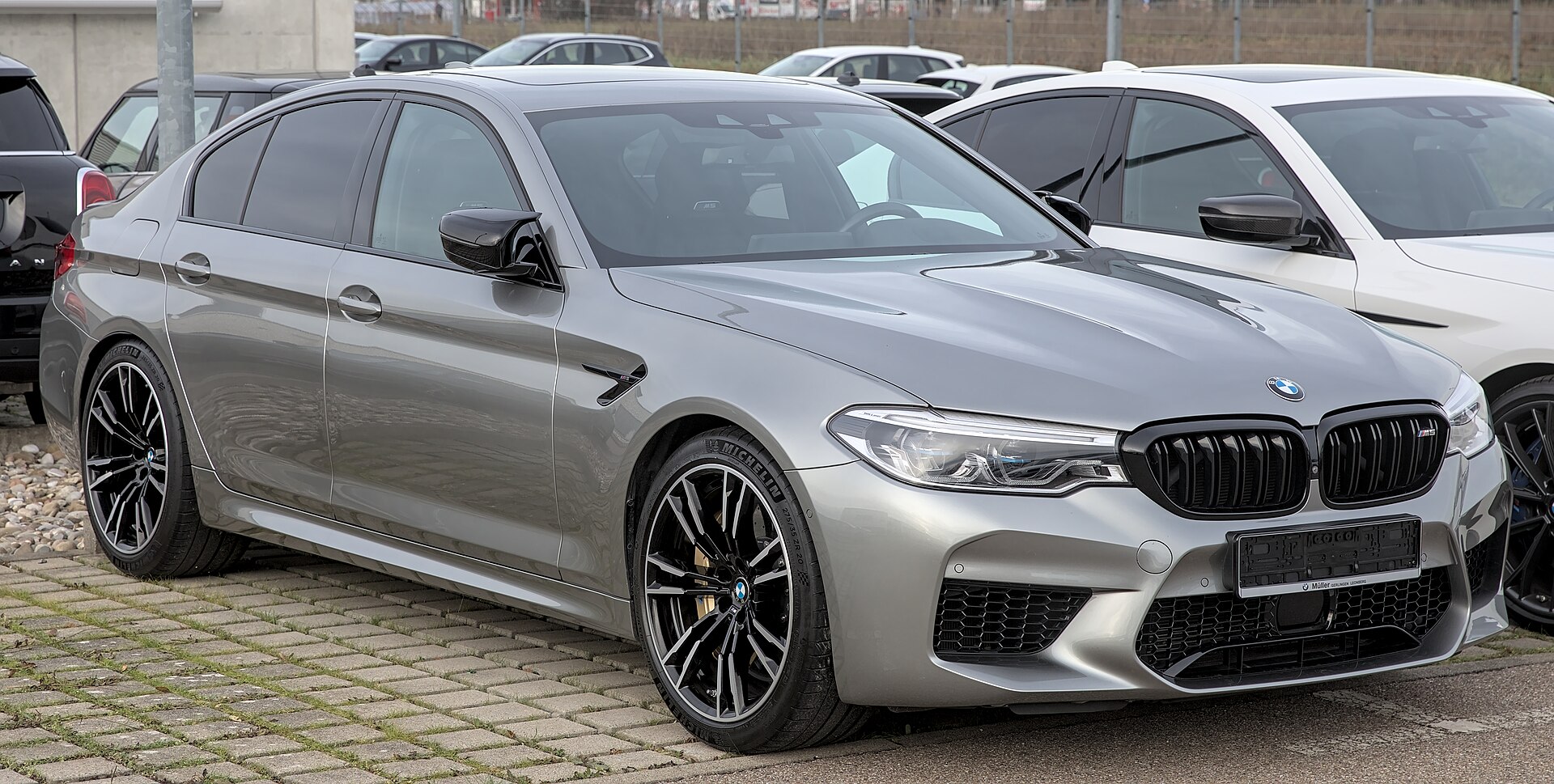 BMW M5 (F90) in blue, front three-quarter view