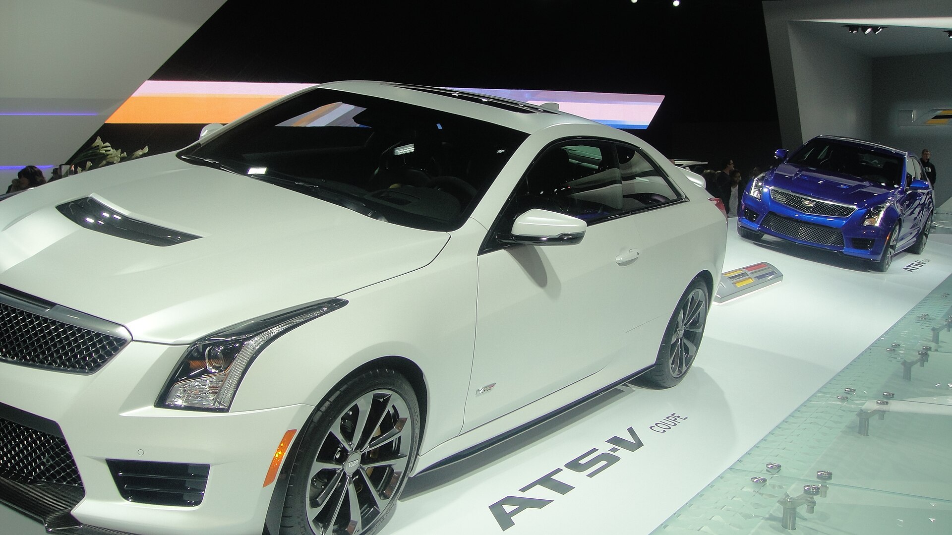 Cadillac ATS-V Coupe and ATS-V sedan at a 2014 auto show.