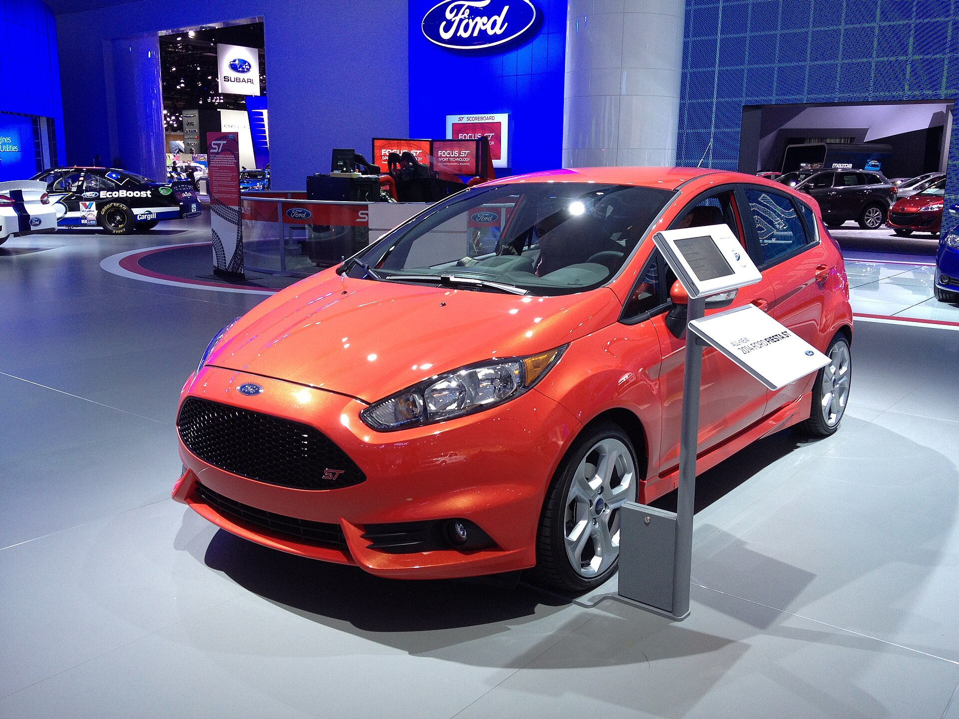2014 Ford Fiesta ST in bright orange, front three-quarter view
