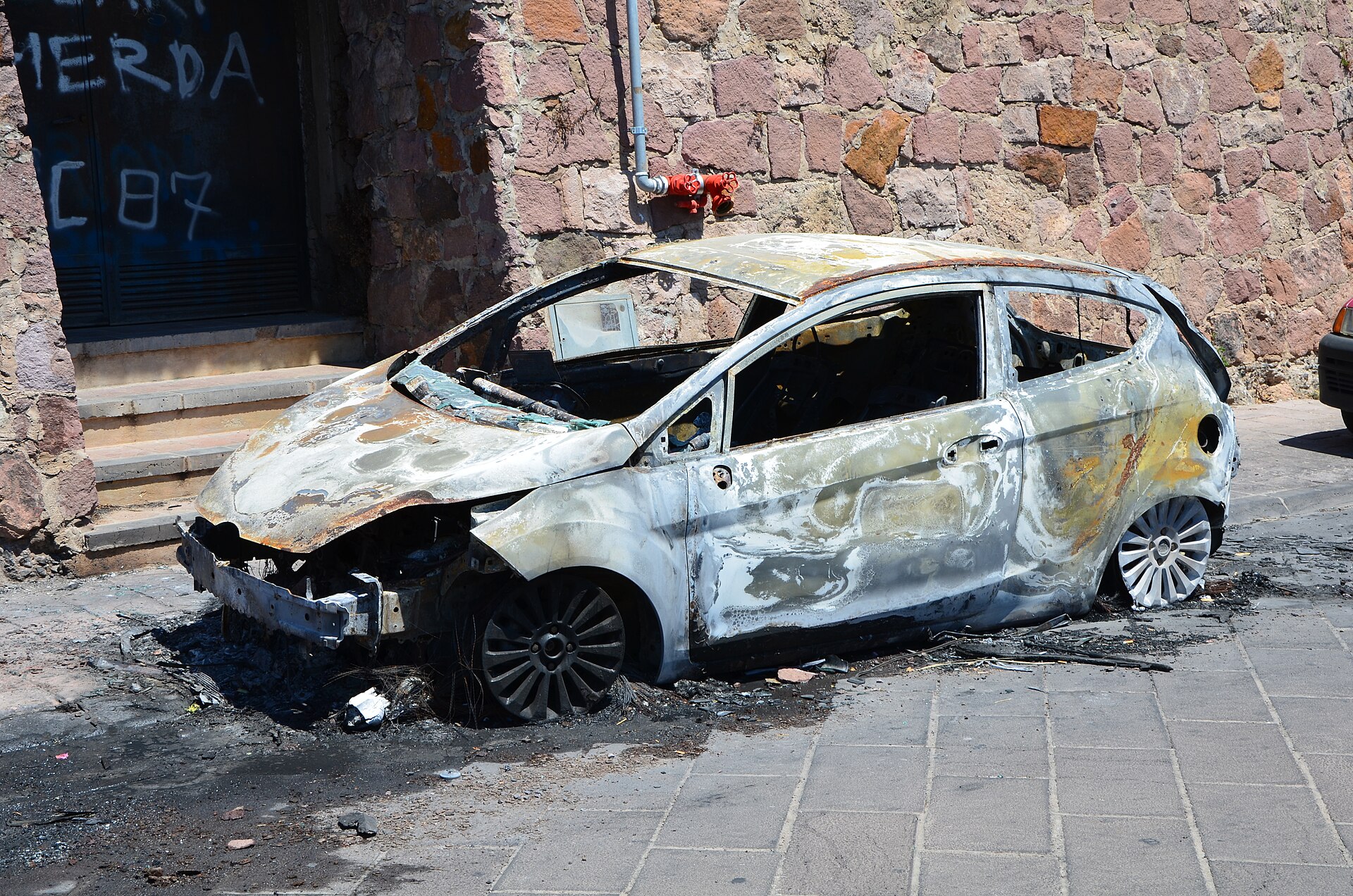 Burnt Ford Fiesta Mk6 after a fire, matching the 2012 X Games crash.