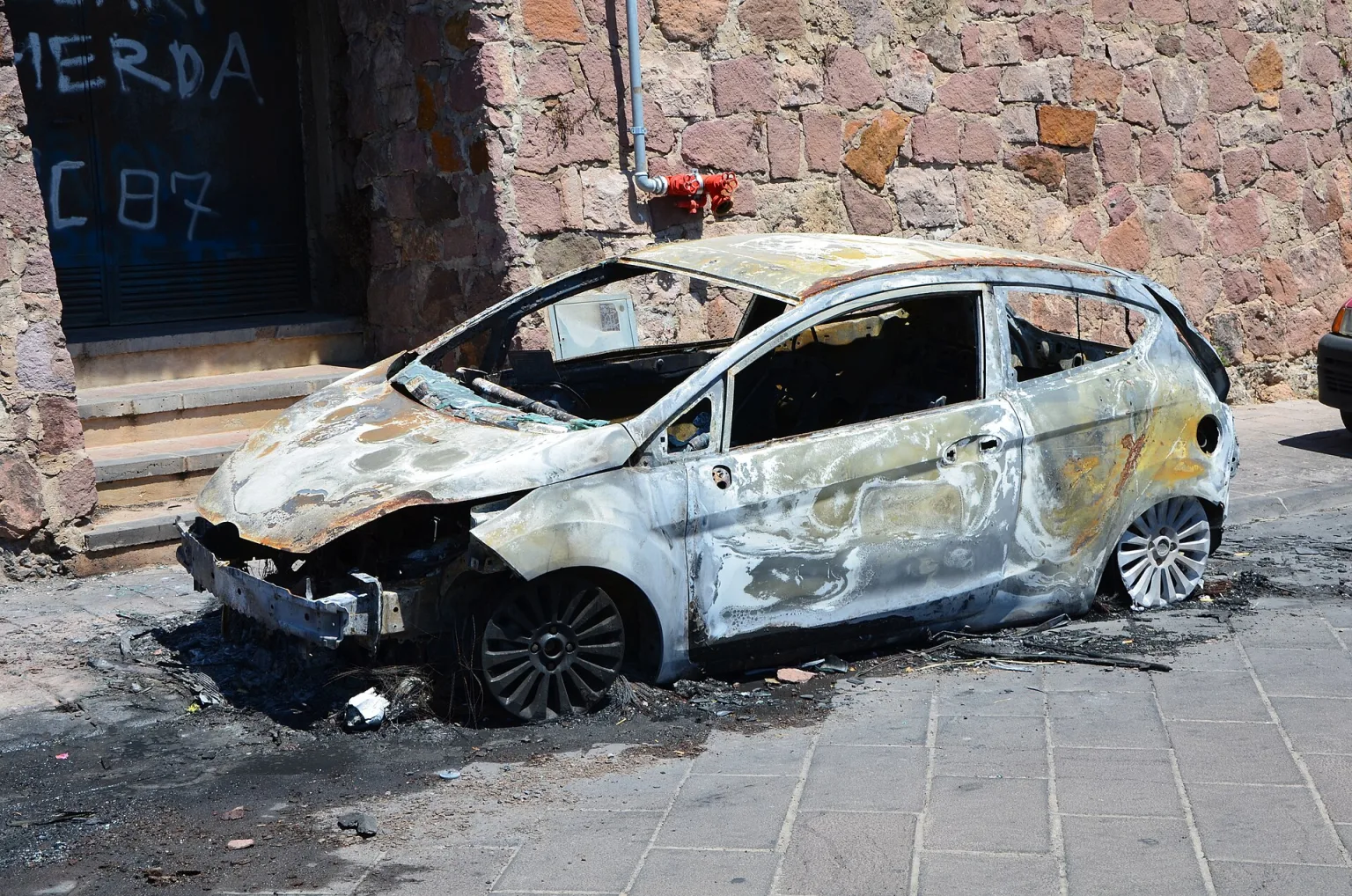 Burnt Ford Fiesta Mk6 after a fire, matching the 2012 X Games crash.