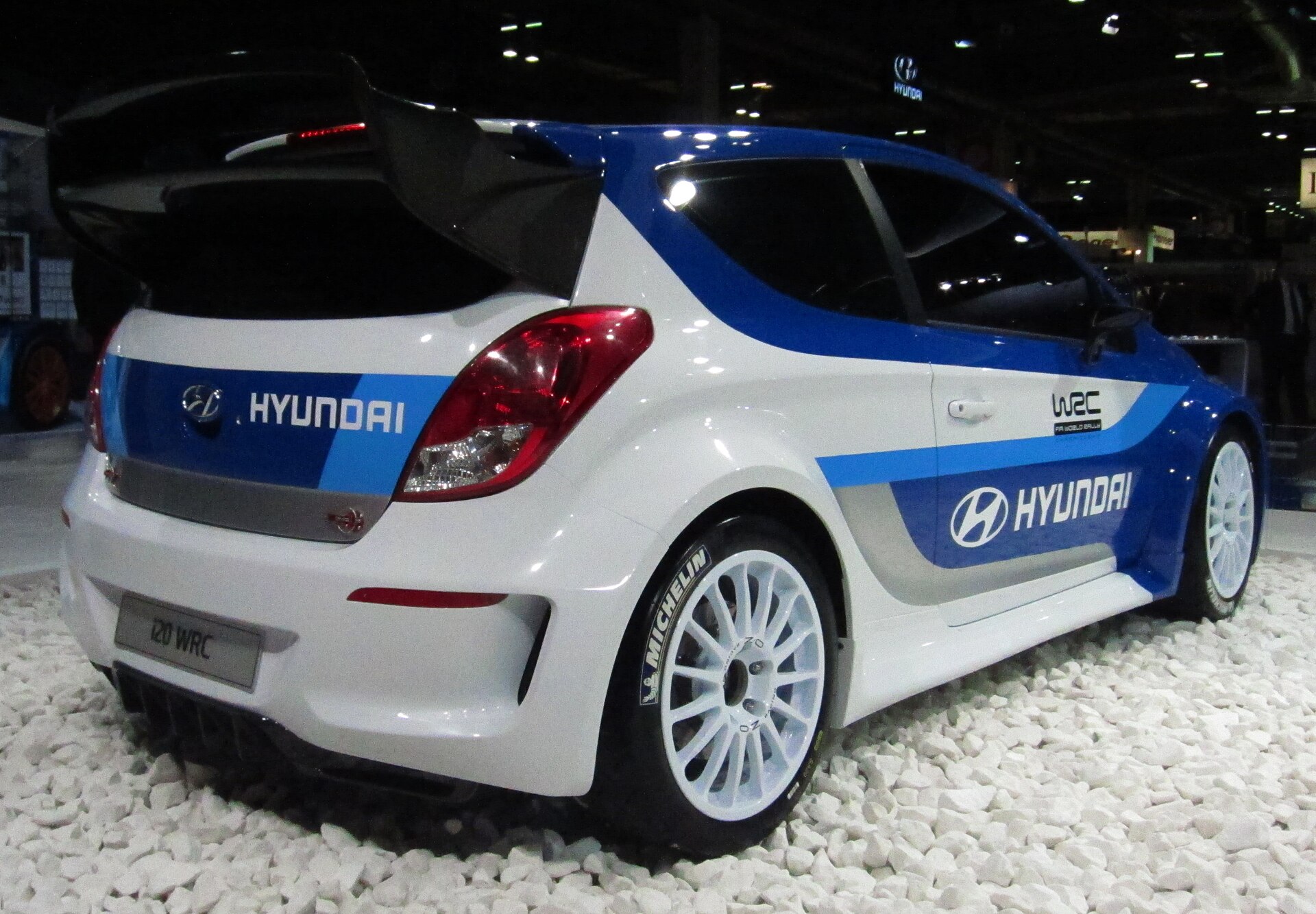 Hyundai i20 WRC at the 2012 Paris Motor Show, rear quarter view.