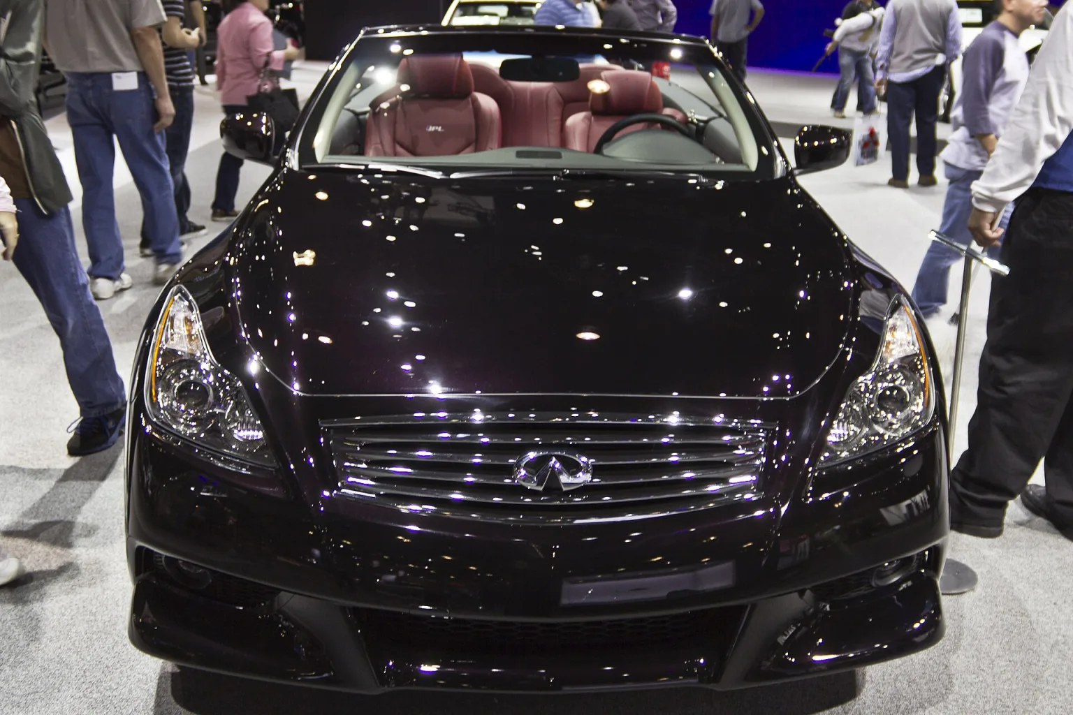 Infiniti G37 IPL Convertible at an auto show, front three-quarter view.