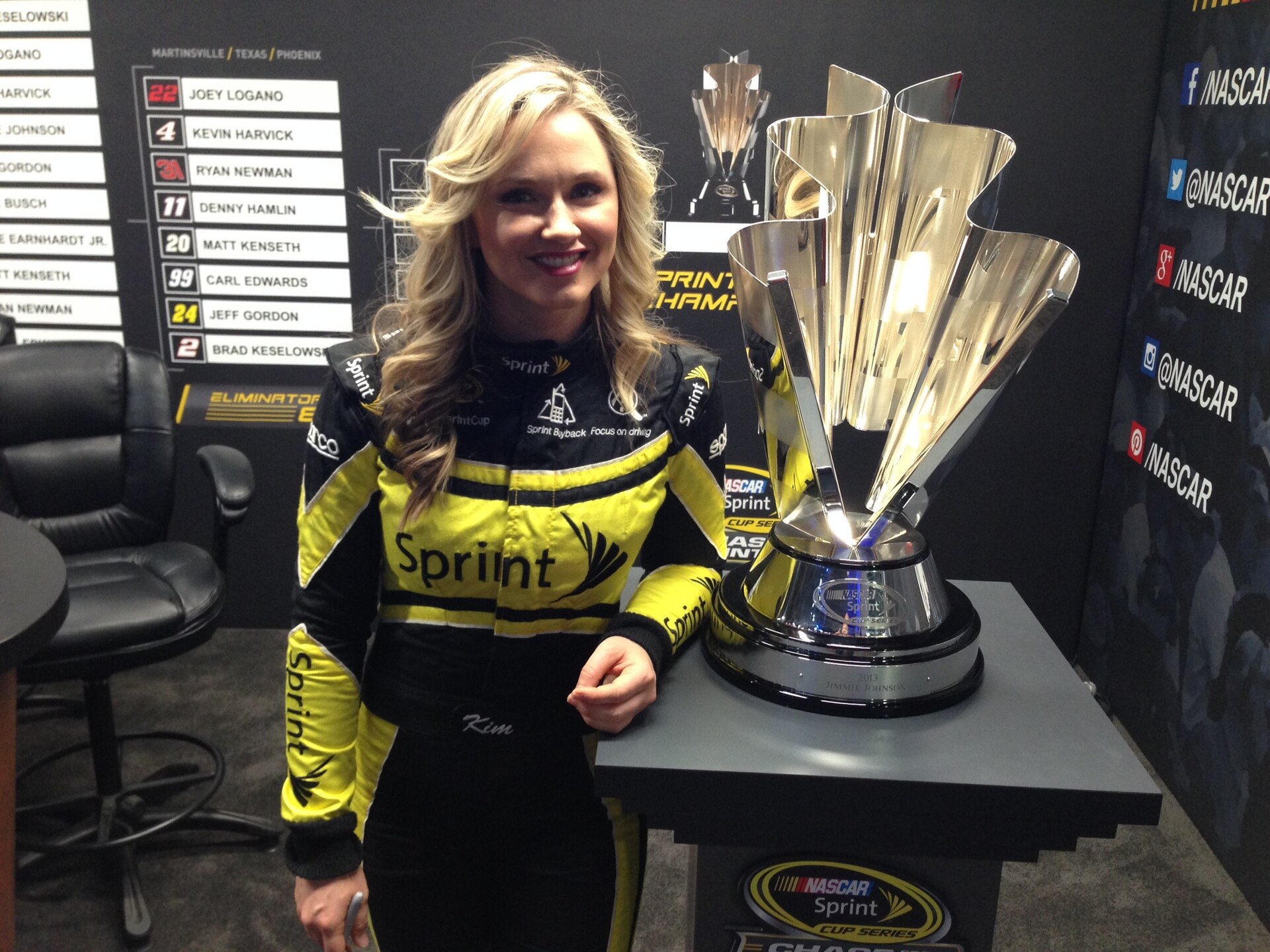 Kim Coon with the Sprint Cup trophy at a NASCAR event.