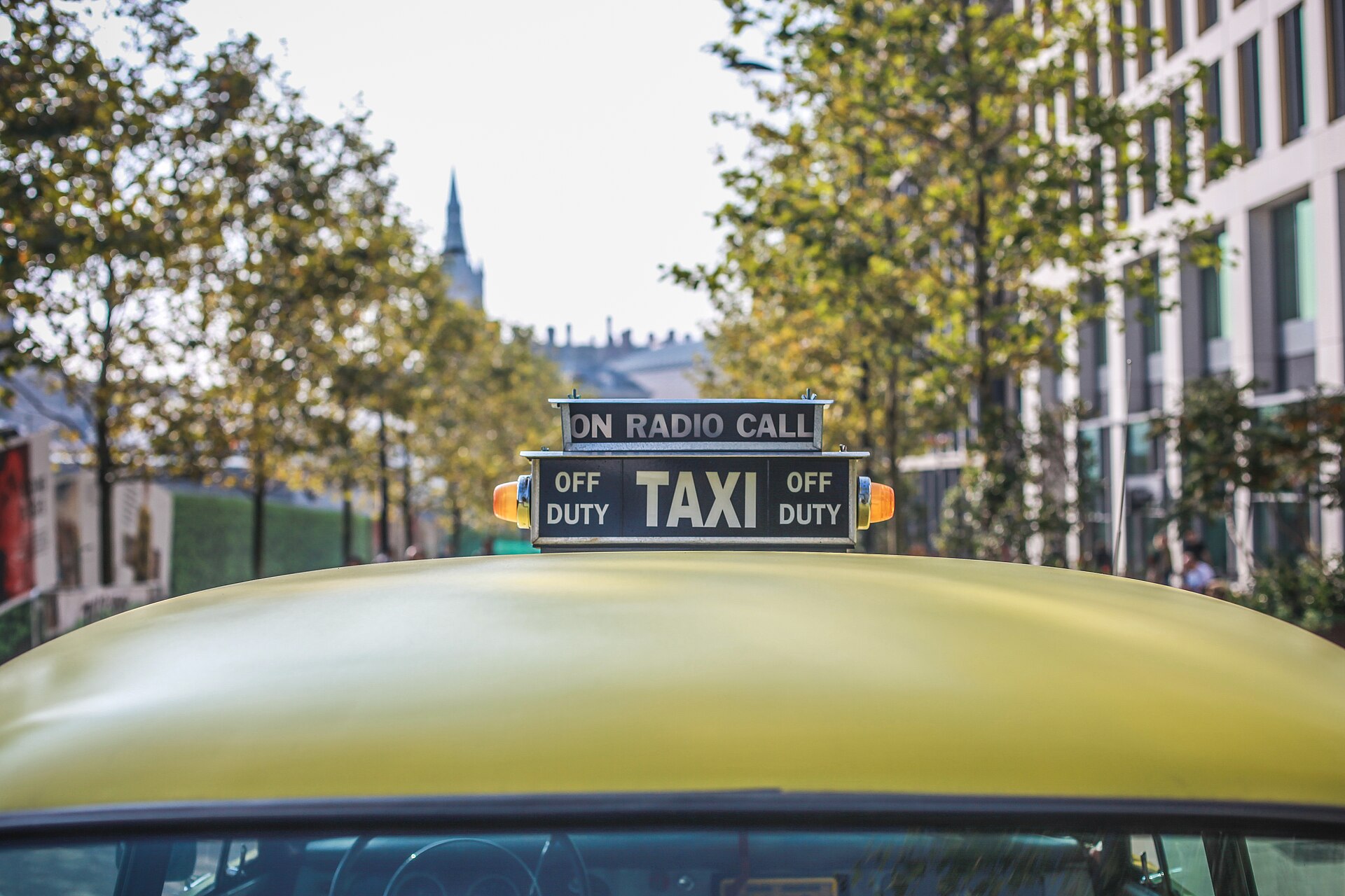 Modern London black cab on a leafy street