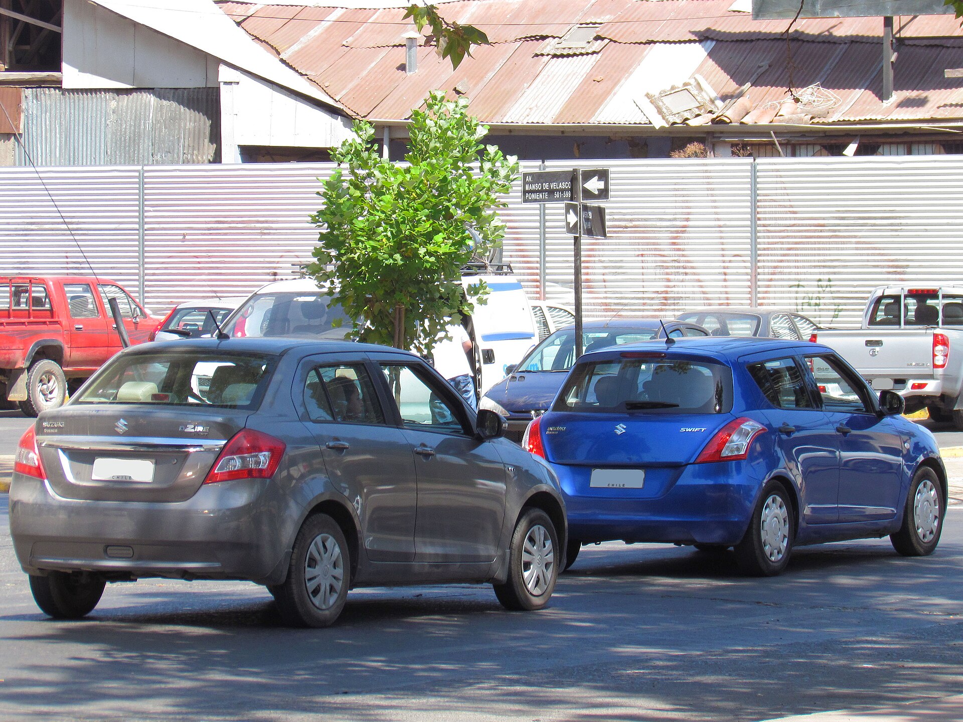 Suzuki Swift Dzire (foreground) and Swift (background), first generation