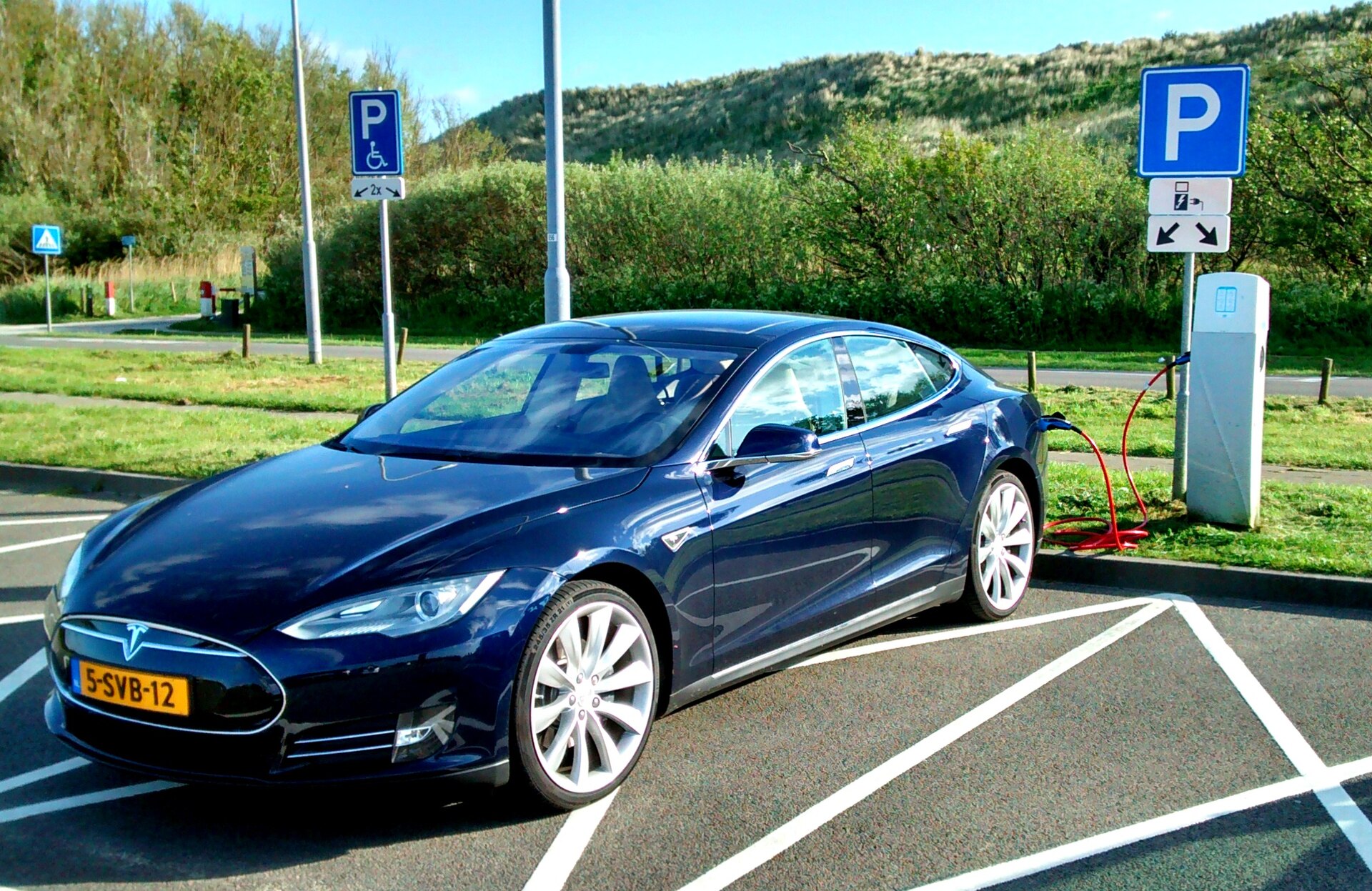 Blue Tesla Model S (first generation) near Zoutelande dunes, Holland