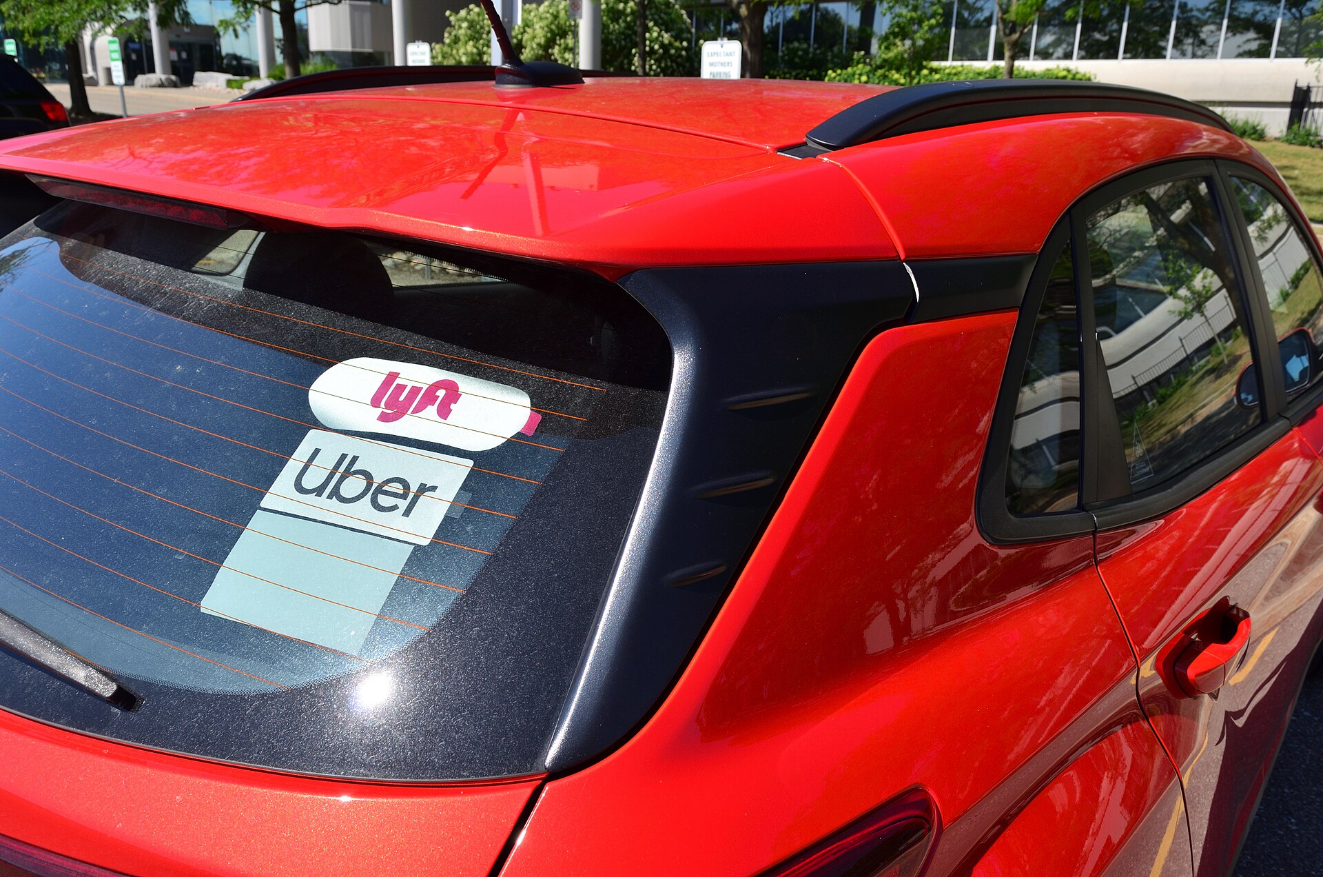 Uber and Lyft branded cars, representing US ride-sharing services.