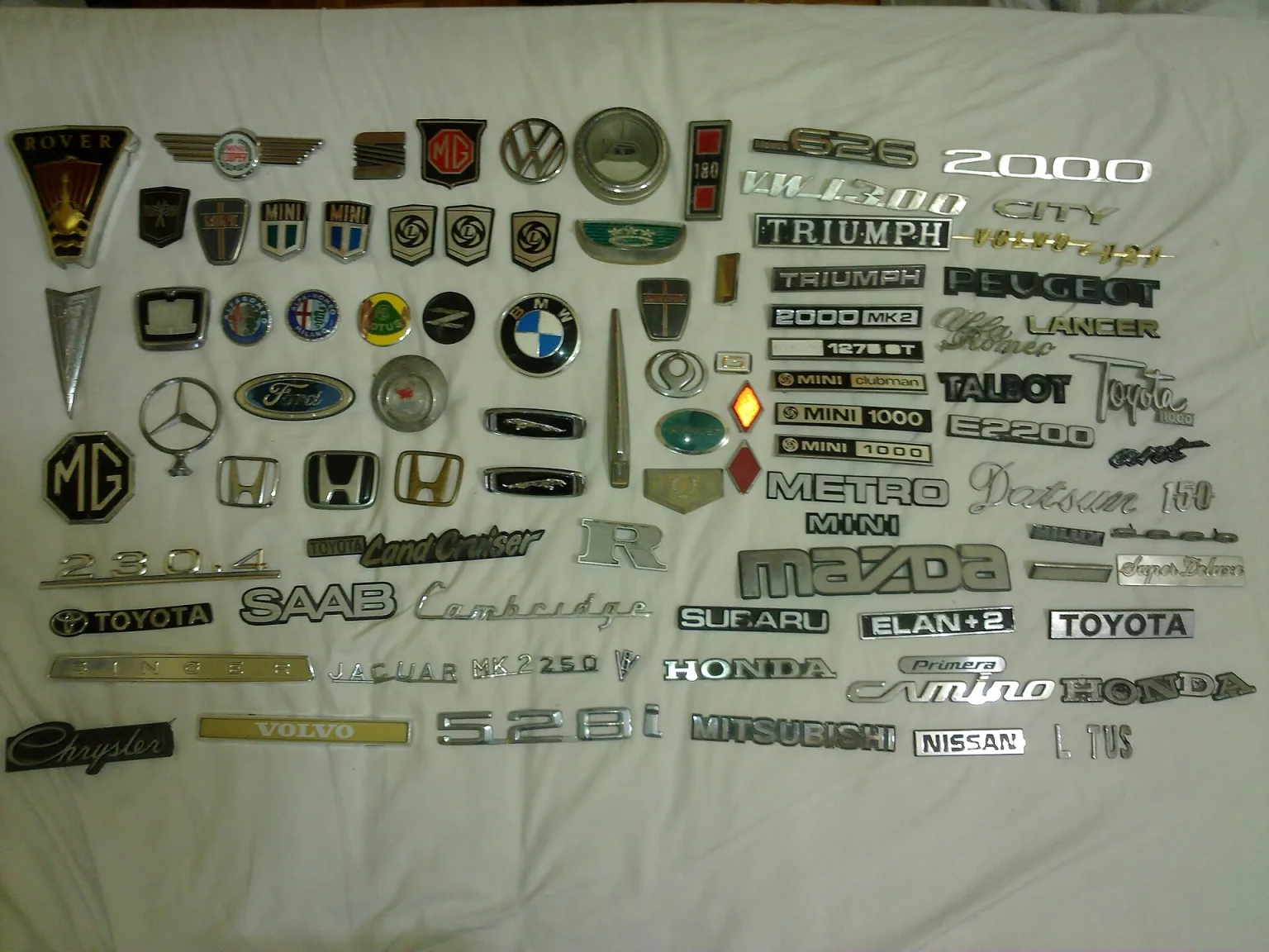 Car emblems from various manufacturers, including VW, Honda, and Chrysler.