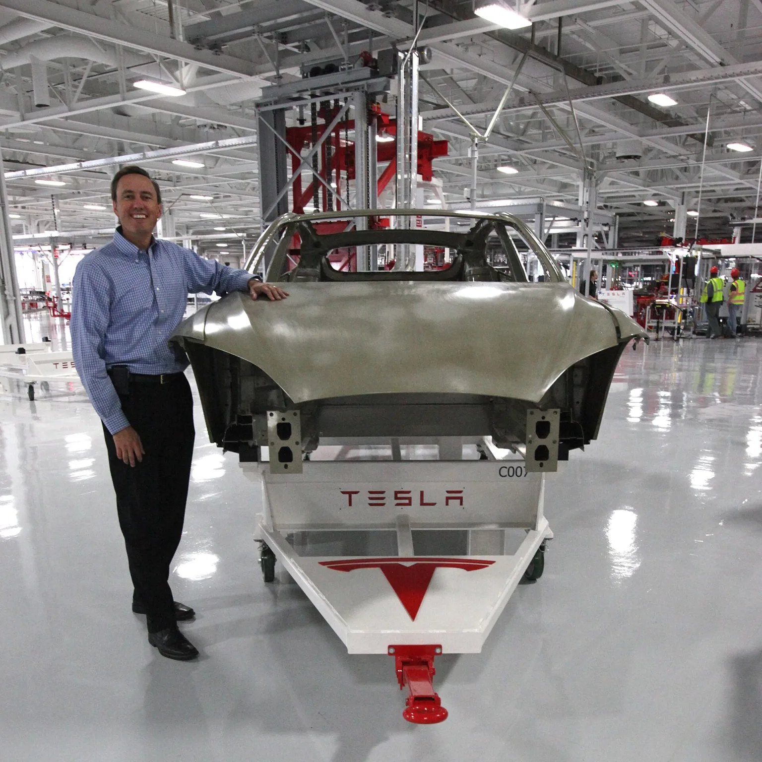 Tesla factory floor with production lines and vehicles