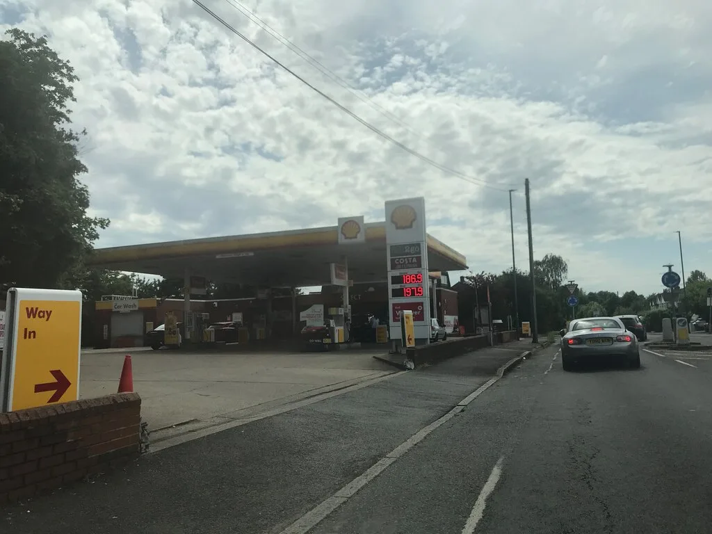Shell fuel station with modern pumps and cars