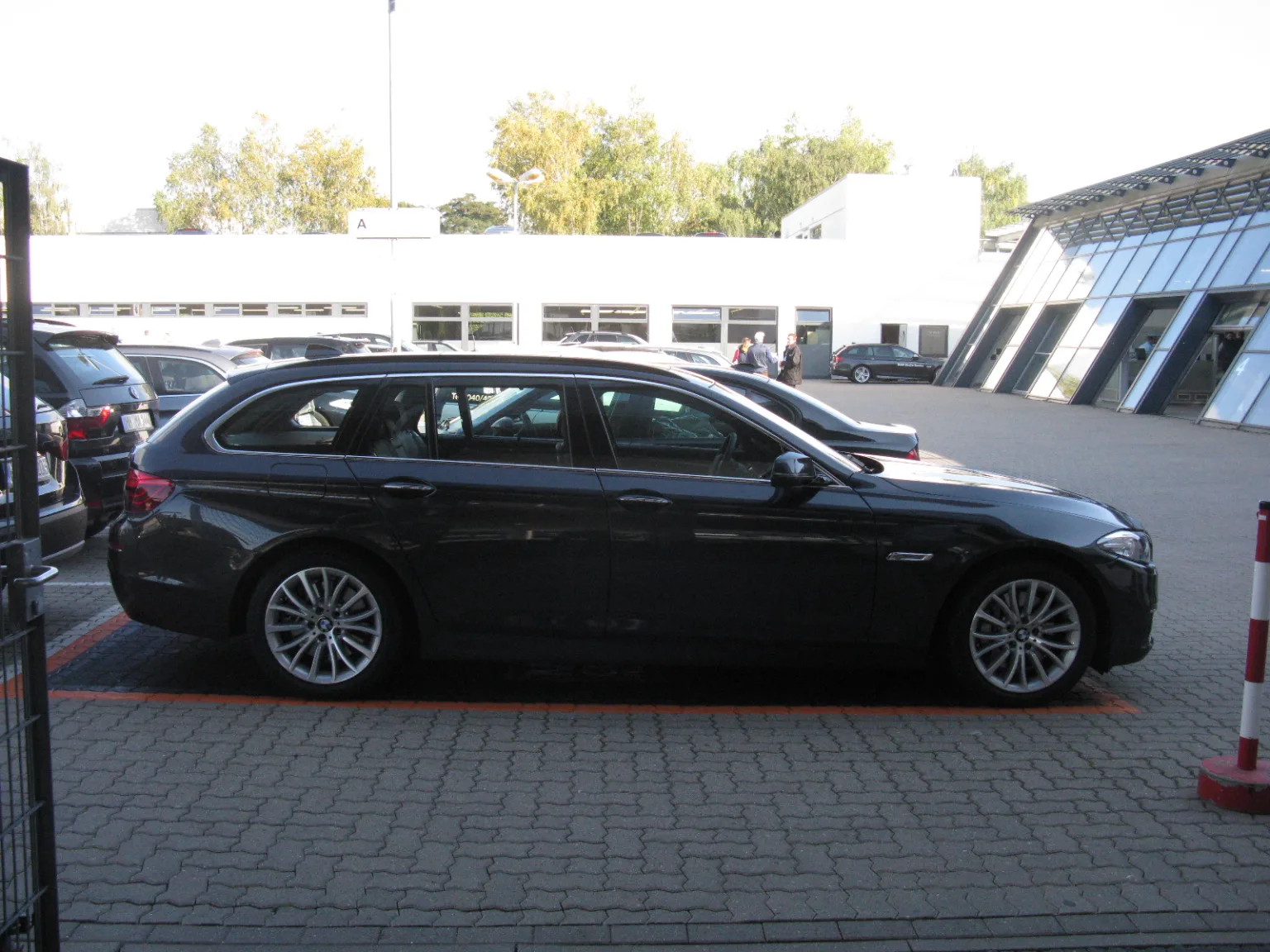 BMW 5 Series Touring F11 in silver, parked on the street