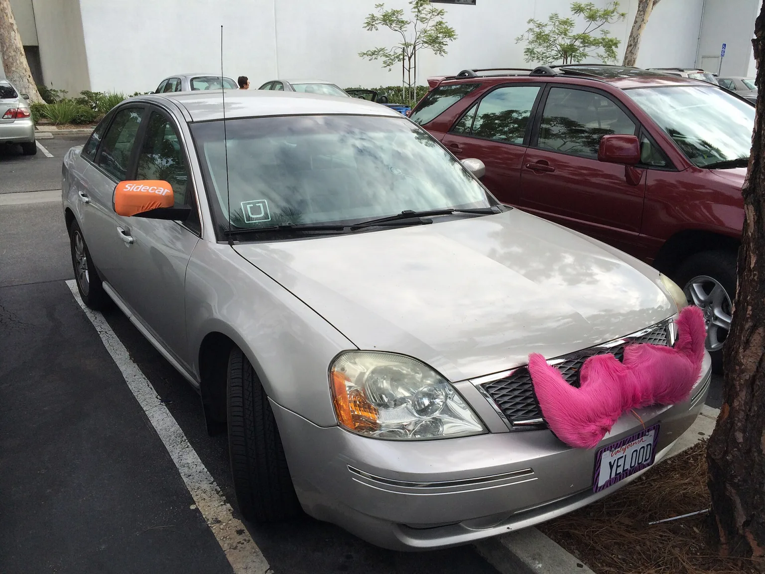 Uber and Lyft vehicles parked side by side on a city street