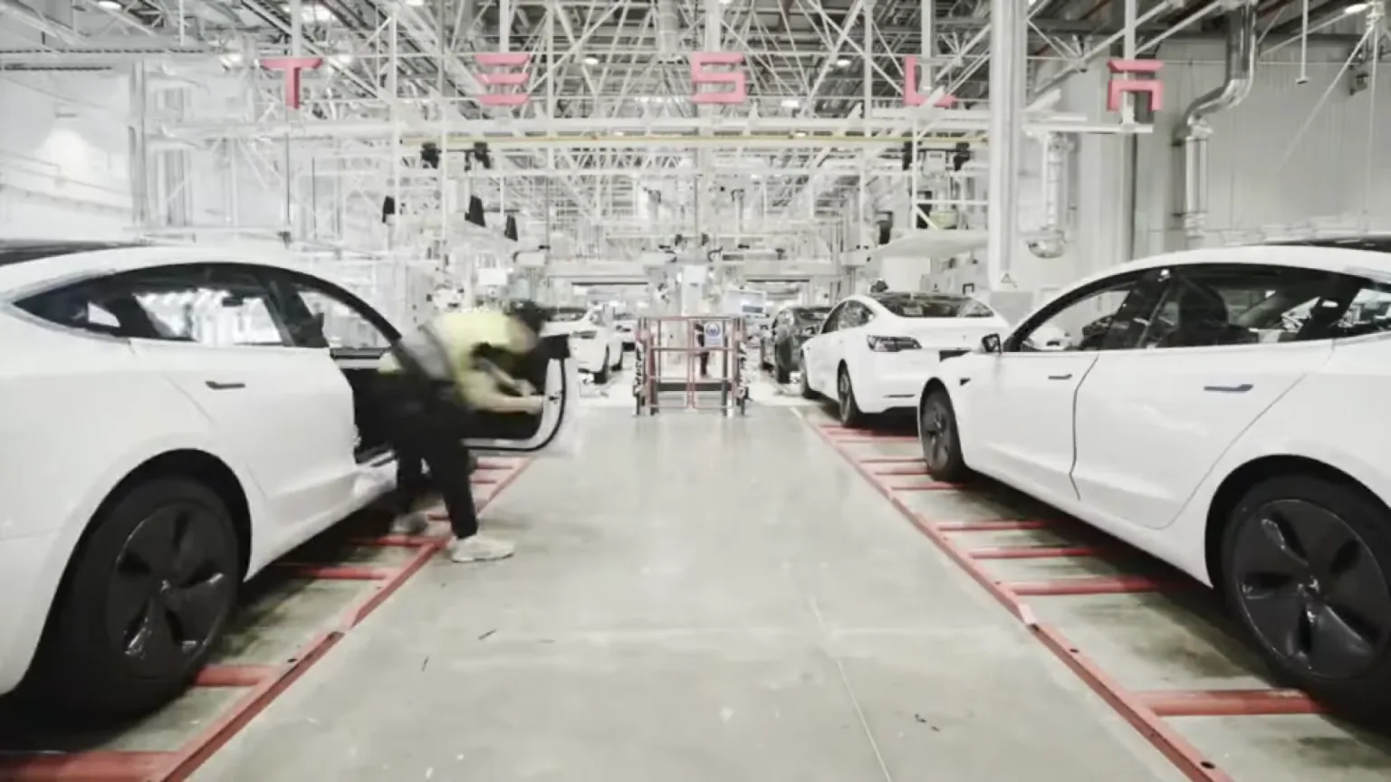 Tesla Gigafactory Shanghai assembly line with contemporary Tesla vehicles
