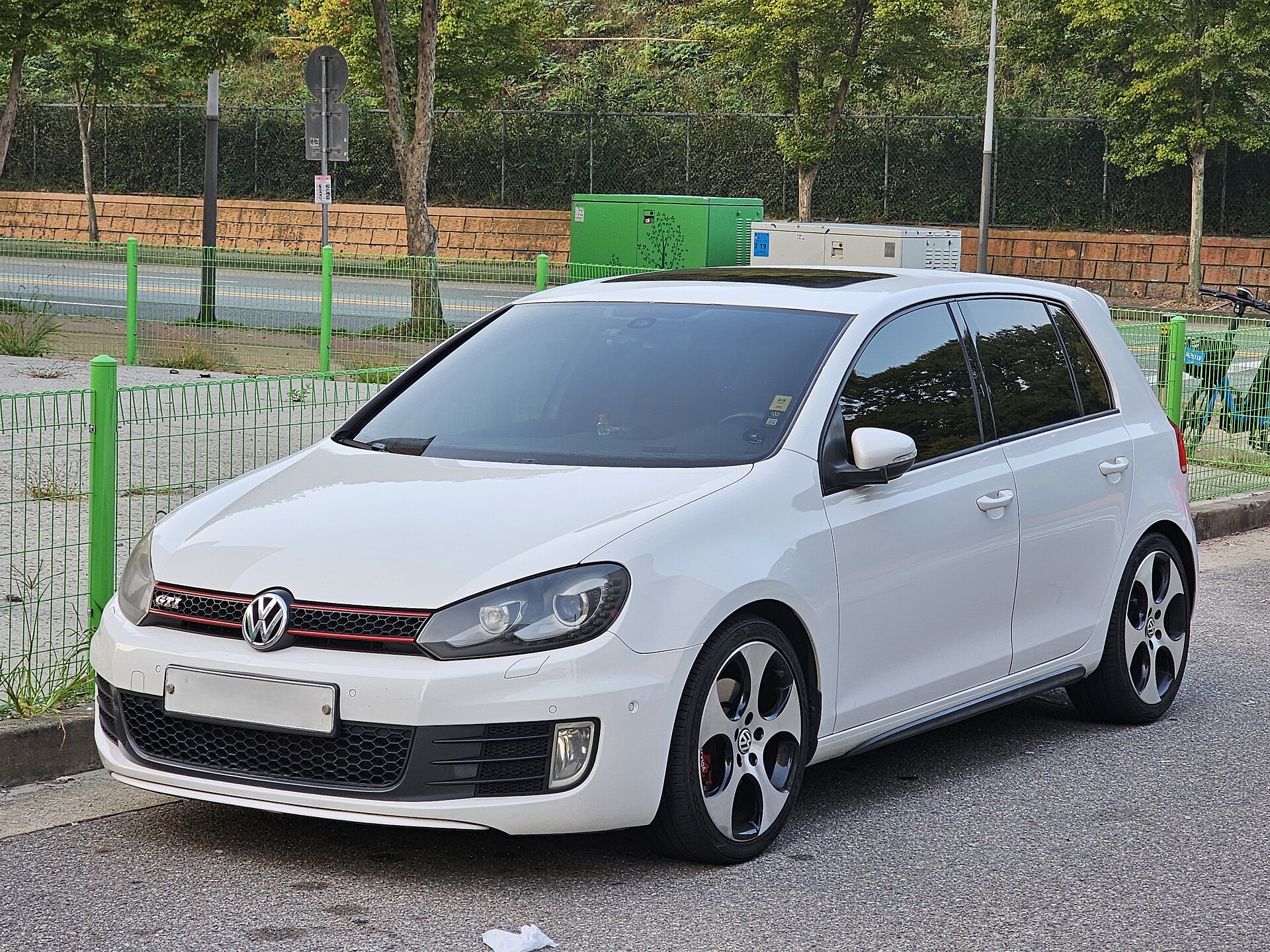 Volkswagen Golf GTI Mk6 in white, front three-quarter view
